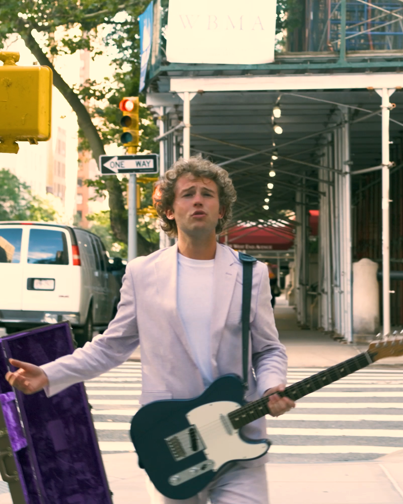Elijah Stone walking with guitar